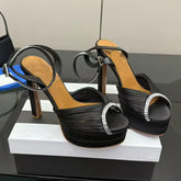 Black platform rhinestone ankle strap heels, pleated satin upper, open toe.