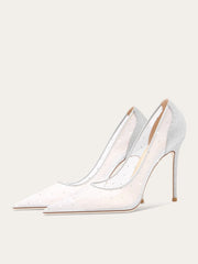 White high-heeled shoes with clear straps on a light gray background