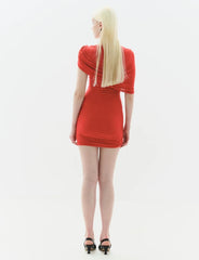 Person wearing a red dress on a white background