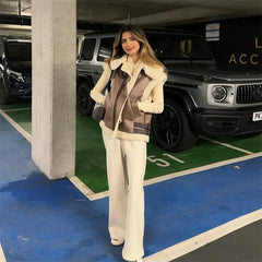 Woman in a stylish outfit standing in a parking garage with cars in the background