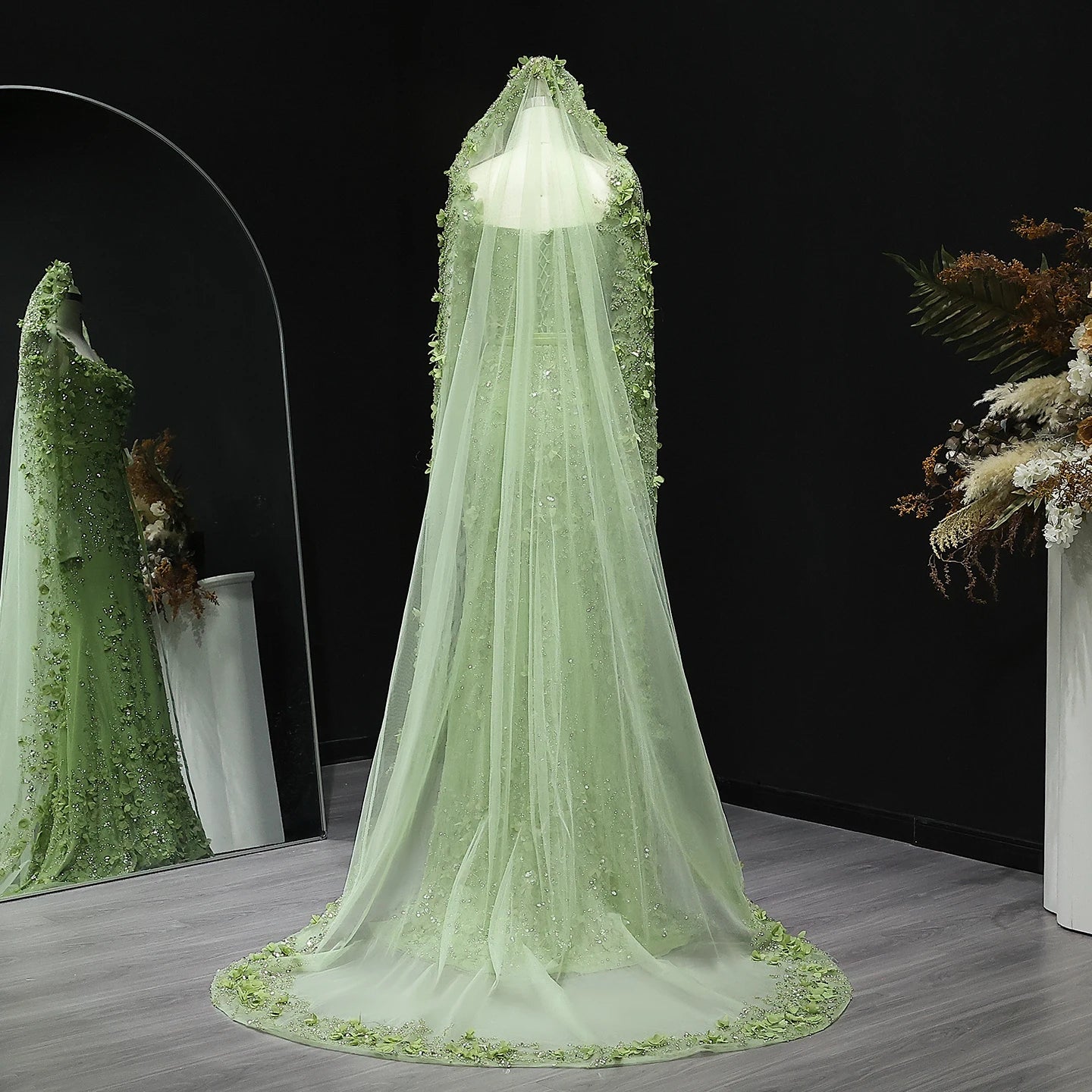 Light green floral embroidered veil on a dark background