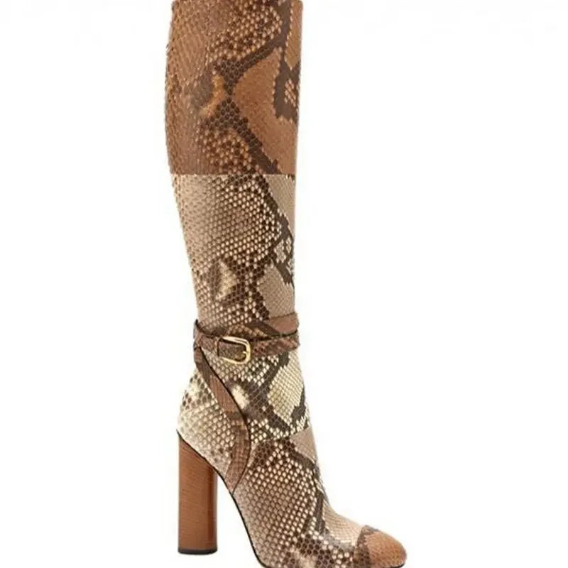Patchwork snake print knee-high dress boots with a buckle strap and chunky square heel.