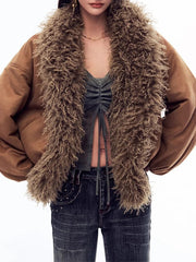 Person wearing a brown jacket with a fluffy brown scarf