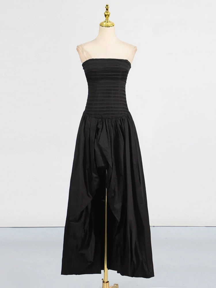Black strapless dress on a mannequin against a white background