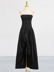 Black strapless dress on a mannequin against a white background