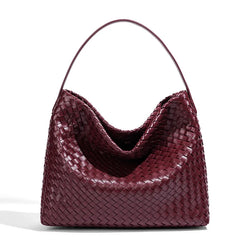 Maroon woven handbag on a white background