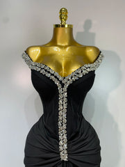 Close-up of the diamond embellishments on the neckline of a draped bandage dress