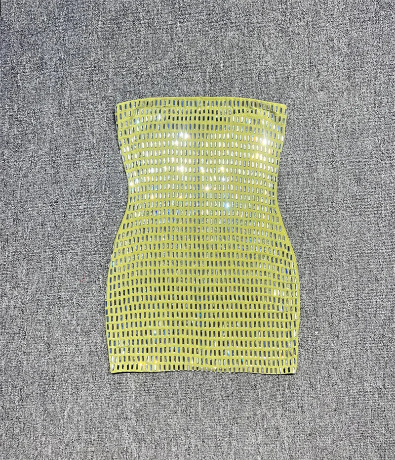 Green strapless dress on a grey textured surface