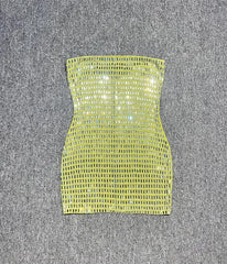 Green strapless dress on a grey textured surface