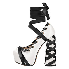 Black and white platform high heel shoe with ribbon detailing on a white background