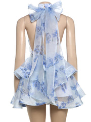 Blue floral dress with a bow on a mannequin against a white background