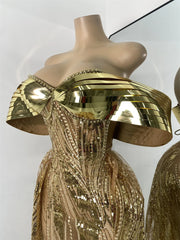 Gold sequin dress with gold headpiece on a mannequin against a white background