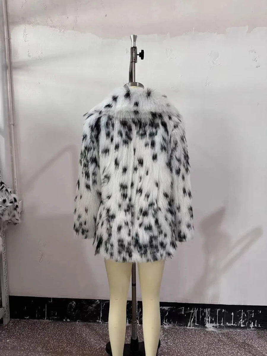 Fur coat with black and white pattern on a mannequin against a plain background