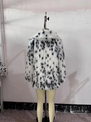 Fur coat with black and white pattern on a mannequin against a plain background