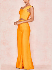 Orange evening gown with sheer mesh panels on a pink background