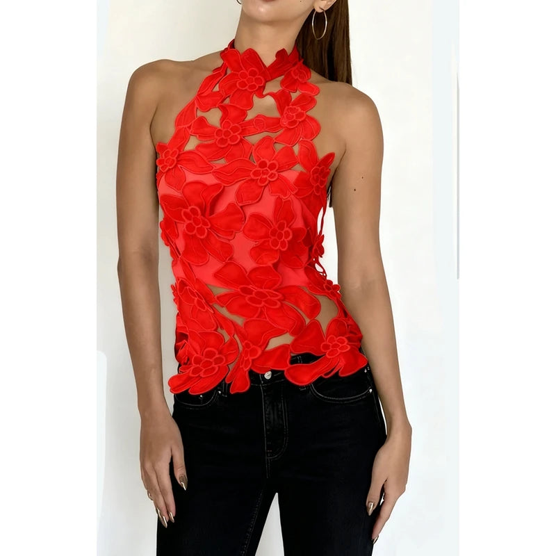 Red floral cutout mock neck halter top shown with black jeans.