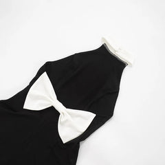 Black swimsuit with a large white bow on a white background