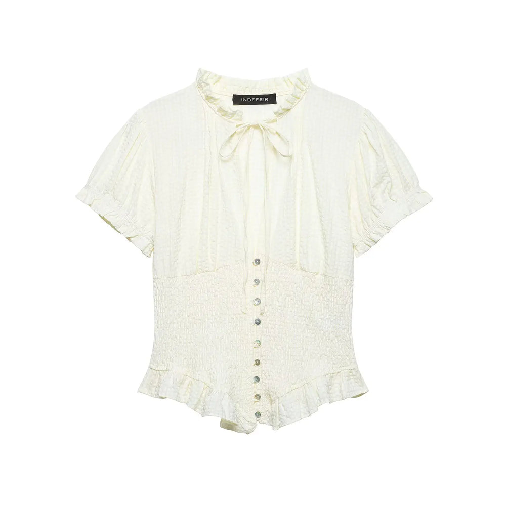 White blouse with ruffled details on a white background