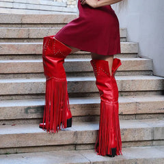 Fringed pointed toe heeled boots on stairs