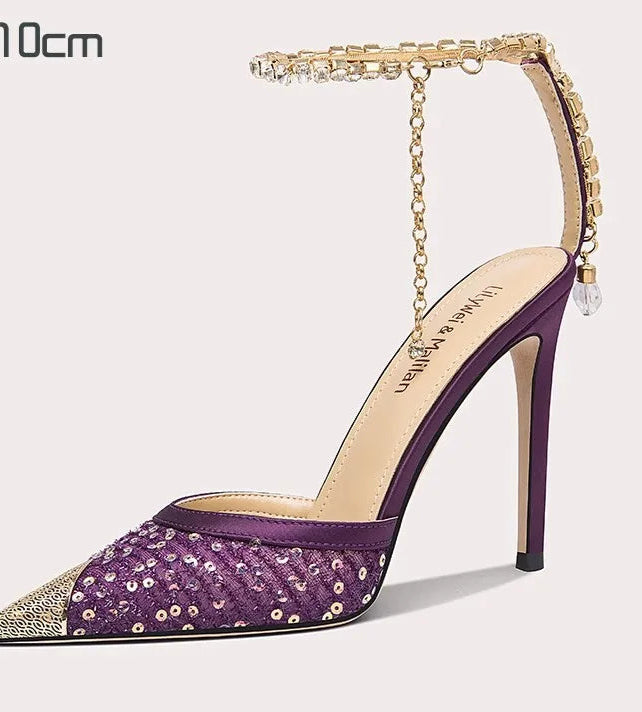 Purple high-heeled shoe with gold accents on a white background