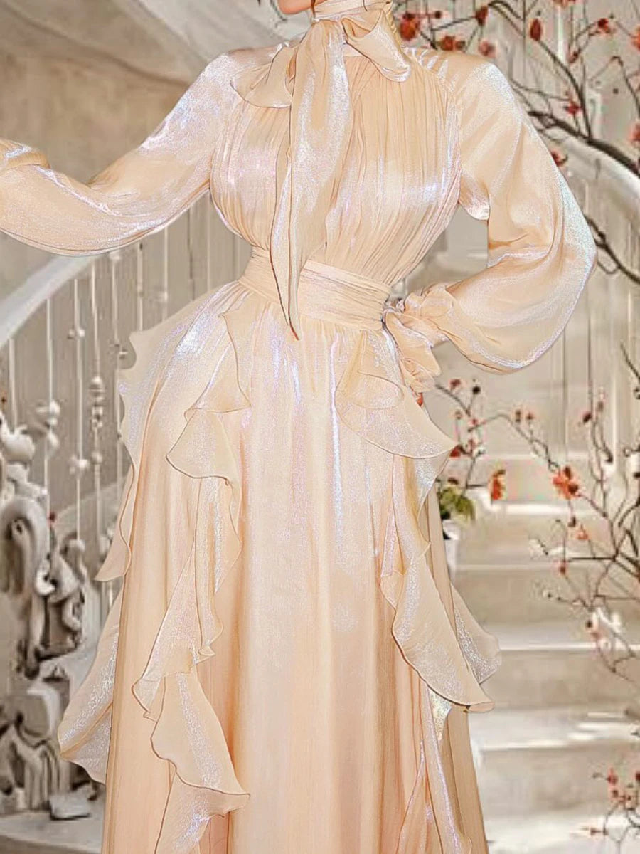 Beige evening gown with long sleeves in a decorative interior setting