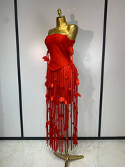 Side view of red strapless bodycon mini dress with tassel trim