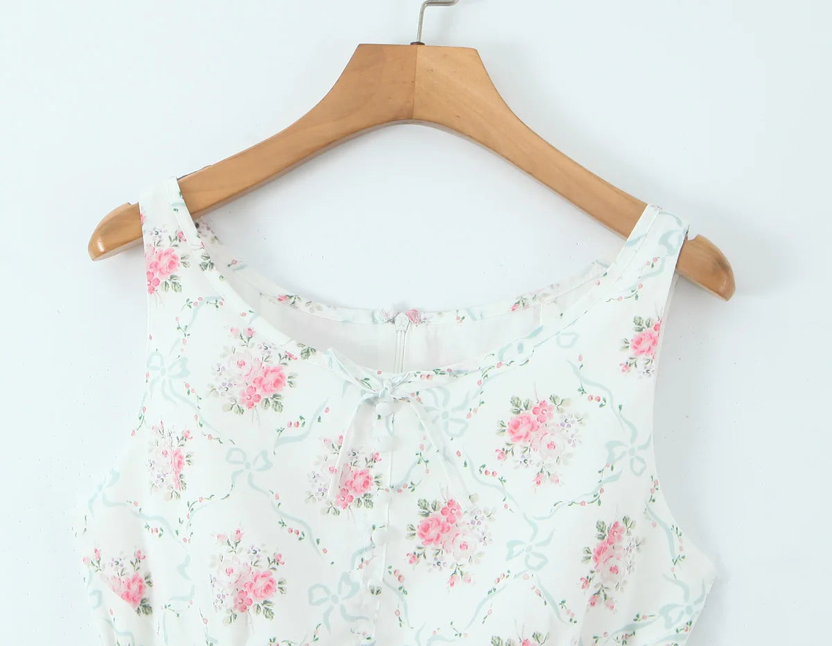 Floral-patterned top on a wooden hanger against a white background