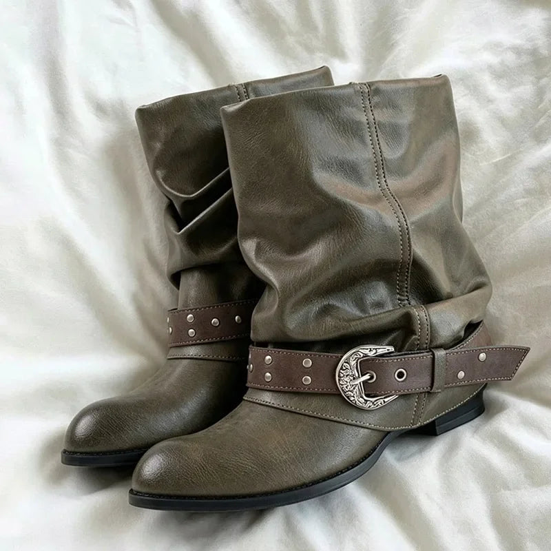 Brown slouch ankle boots with a round toe and decorative buckle strap.
