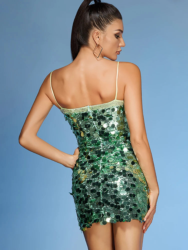 Woman wearing a green sequin dress against a blue background
