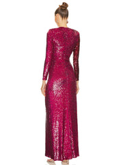 Woman wearing a long, sparkly burgundy dress on a white background