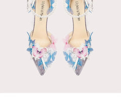 Decorative high-heeled shoes with floral designs and beaded details on a light background