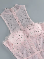 Pink sleeveless top with sequin details on a gray background