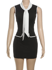 Black dress with a white tie neckline on a mannequin against a white background