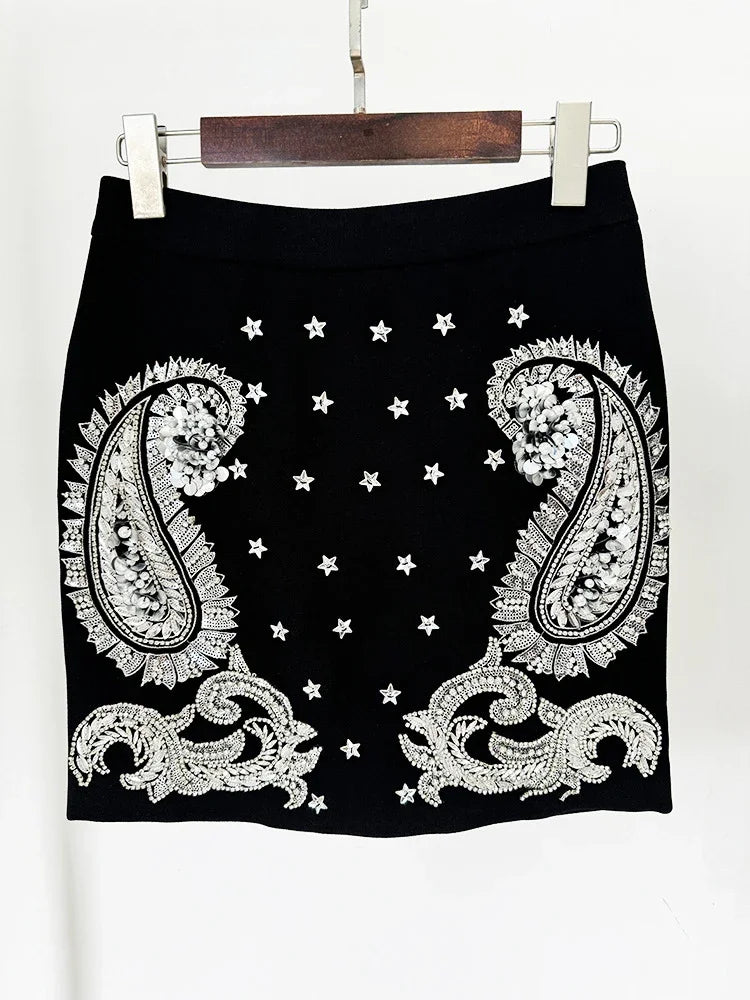 Black skirt with white paisley patterns and star designs on a white background