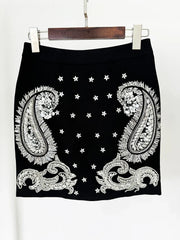 Black skirt with white paisley patterns and star designs on a white background