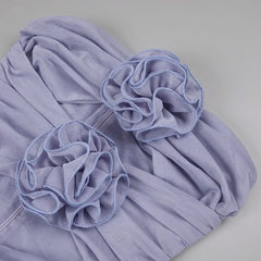 Light purple fabric with floral embellishments on a gray background