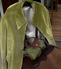 Green velvet coat and handbag in an indoor setting