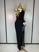 Black strapless dress with floral appliqués and high slit