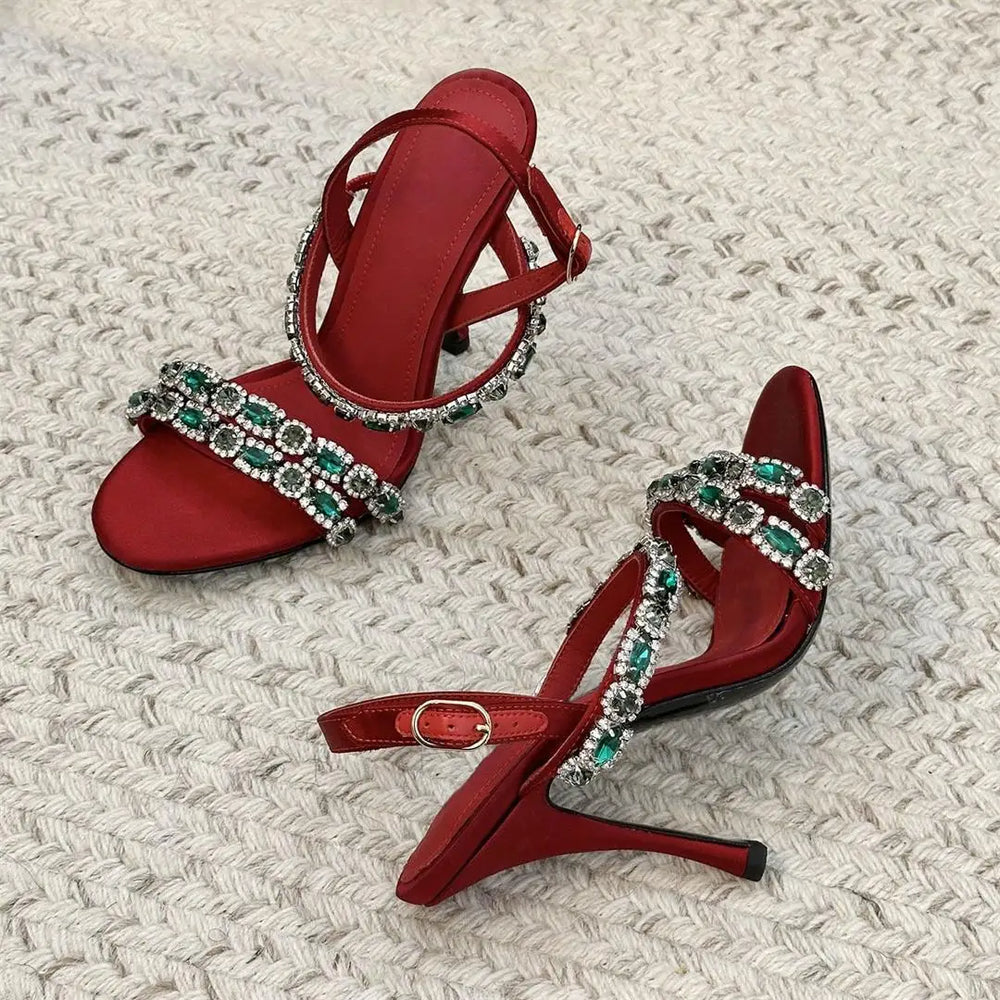 Pair of red crystal embellished stiletto sandals angled