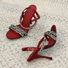 Pair of red crystal embellished stiletto sandals angled