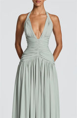 Mint green halter neck gown on a plain background