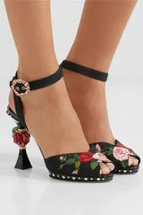 Close-up of floral sculpted heel sandals on a model