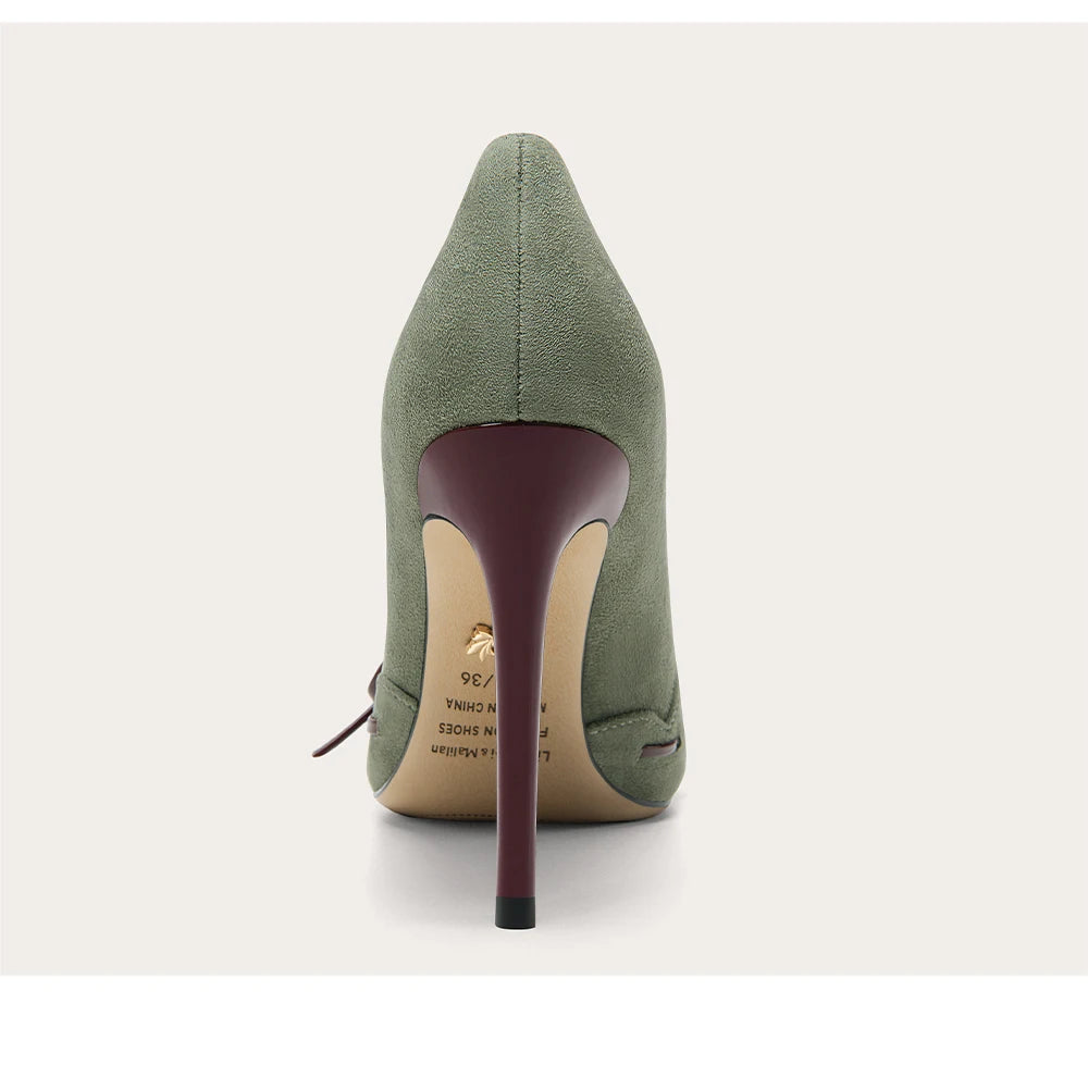 Green high-heeled shoe on a white background