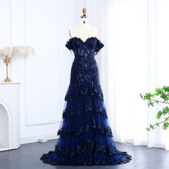 Blue evening gown on a mannequin against a white curtain background