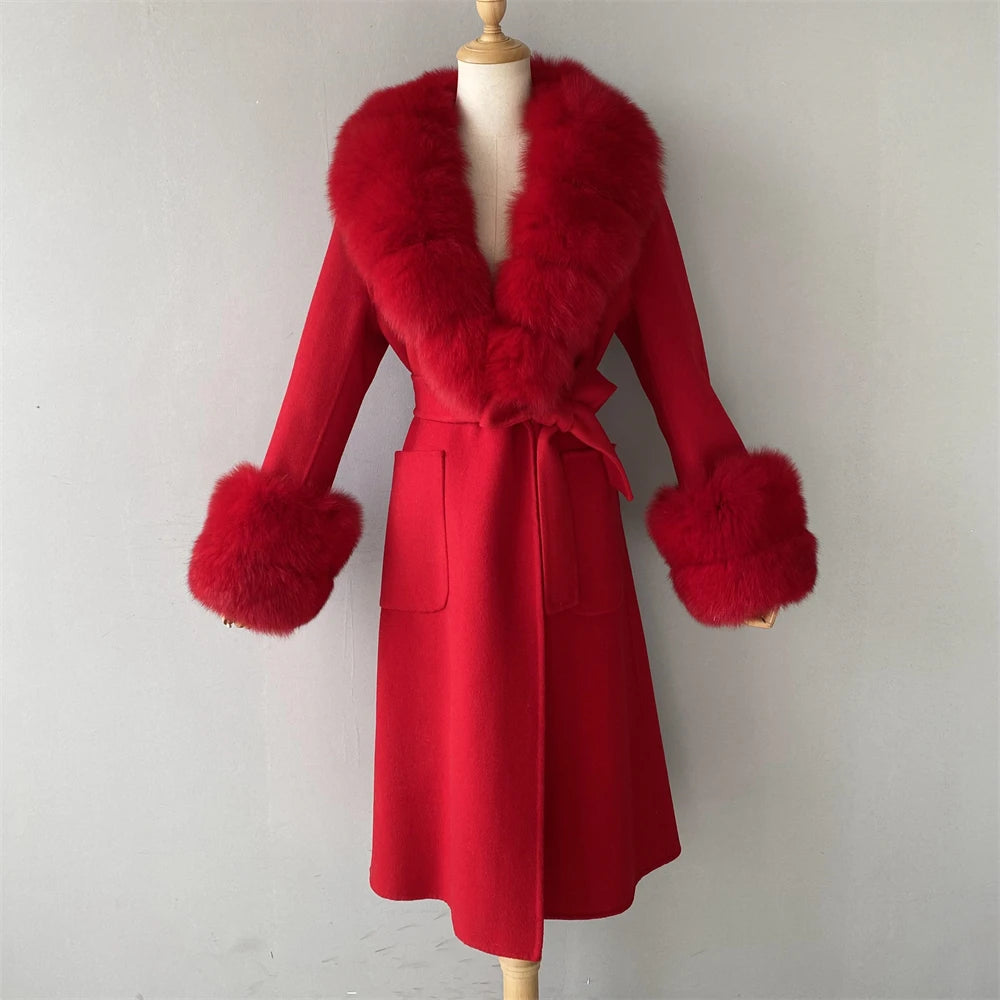 Red coat with fur trim on a mannequin against a plain background