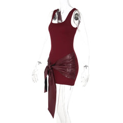 Maroon dress with leather accents on a mannequin against a white background