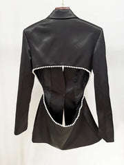 Black leather jacket with pearl embellishments on a white background