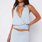 Light blue top with cut-out design on a white background