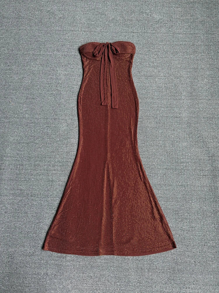 Front view of a sequin strapless maxi dress with a bow detail.