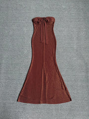 Front view of a sequin strapless maxi dress with a bow detail.